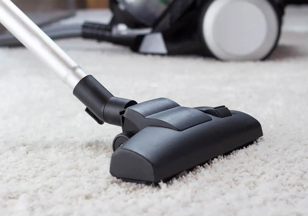 Vacuum on top of a white carpet