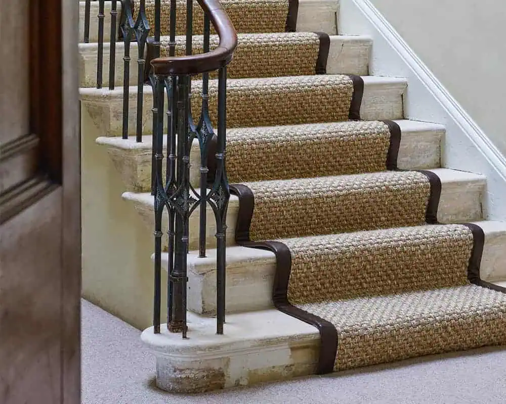 A sisal stair runner installed over underlay on stairs