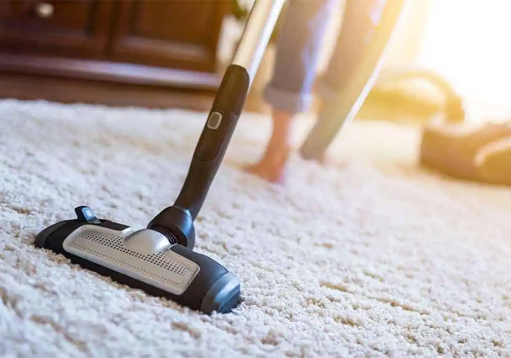 Woman vacuuming a carpet