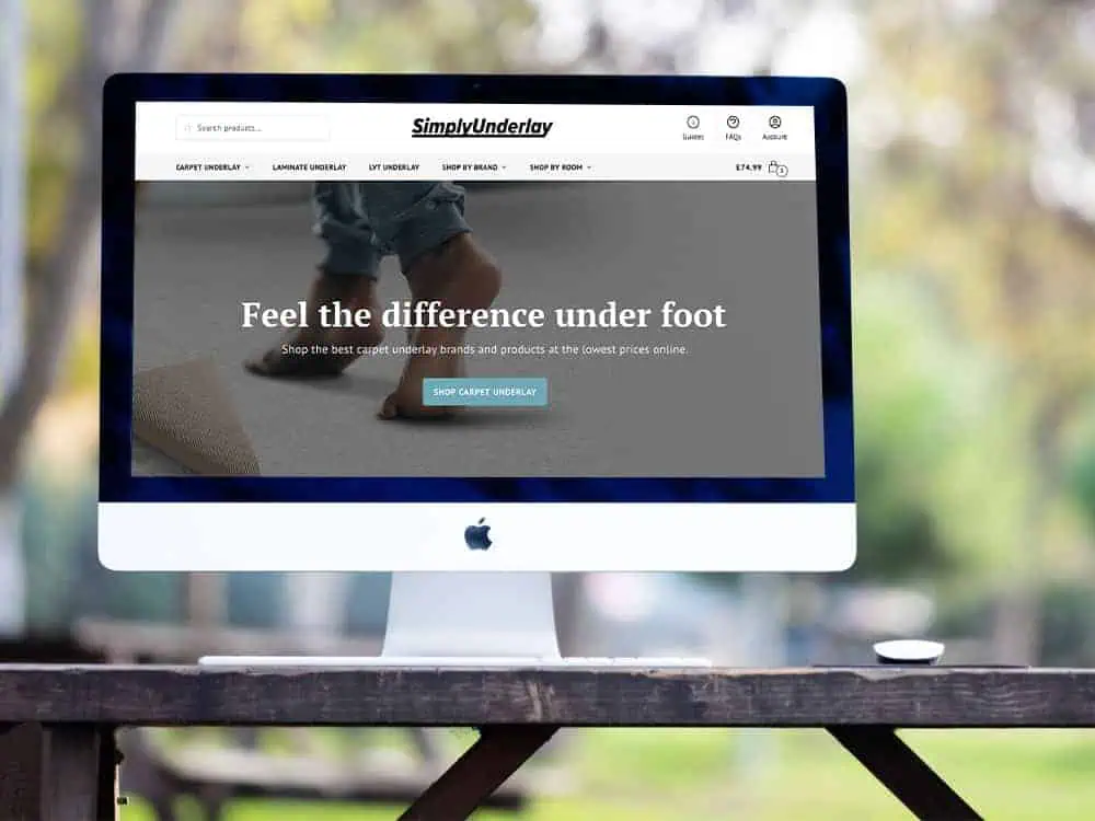Apple iMac computer on a desk with a specialist underlay retailer website on the screen