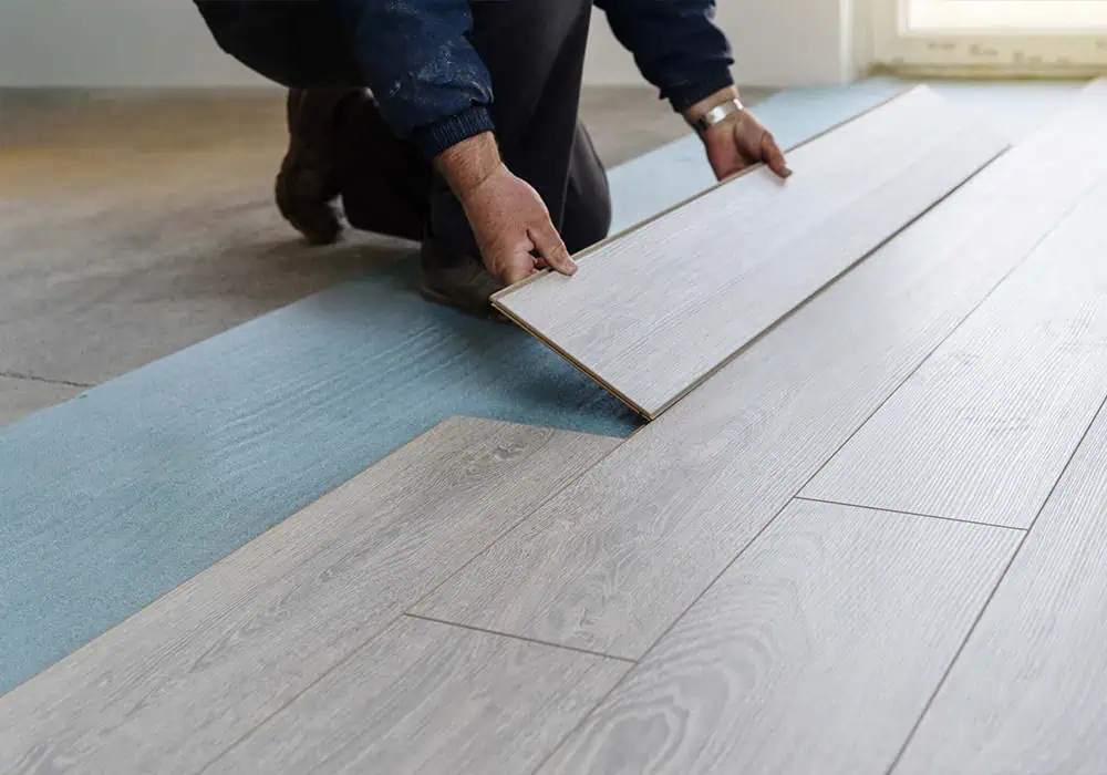 Man laying laminate boards over a think foam underlay