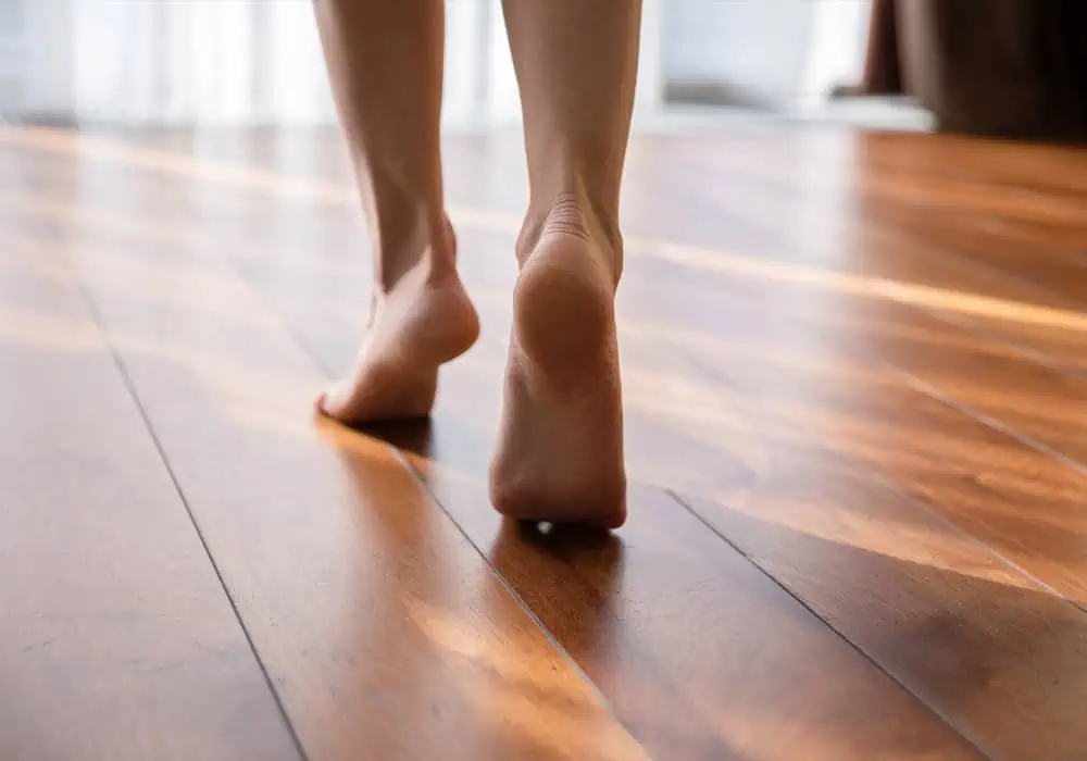 Woman walking bare foot on laminate flooring