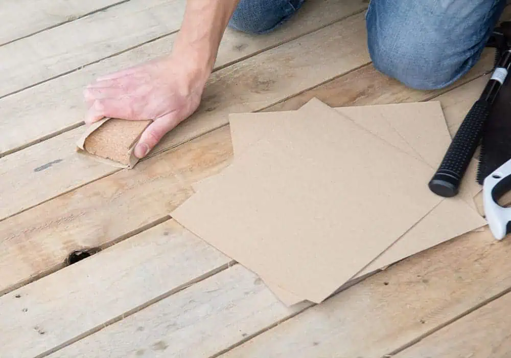 Man prepping a wooden subfloor