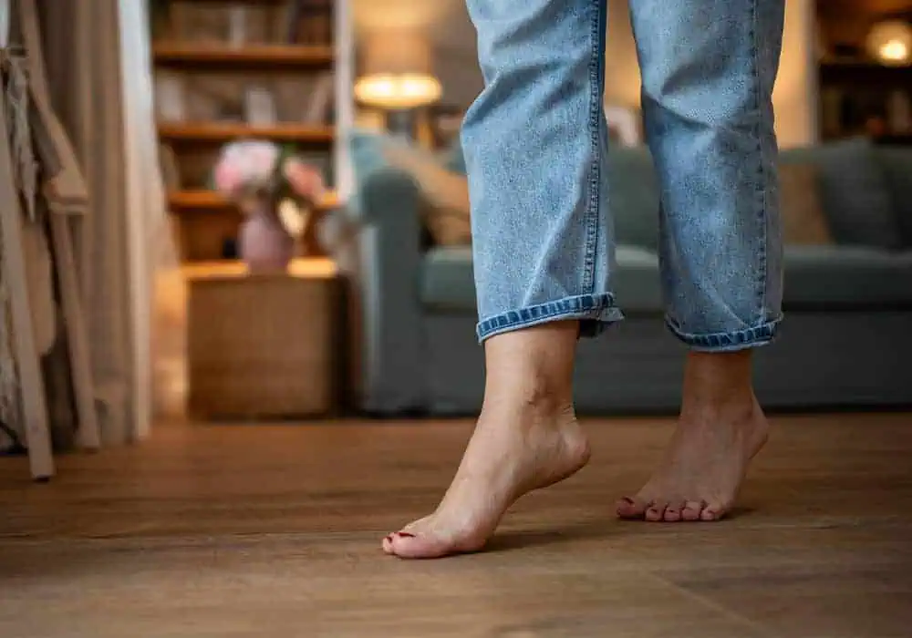 Woman walking barefoot on comfortable laminate floor with underlay underneath