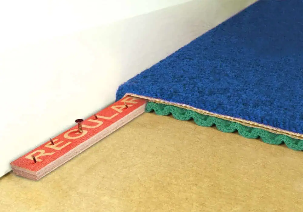 Carpet gripper holding carpet on its pins