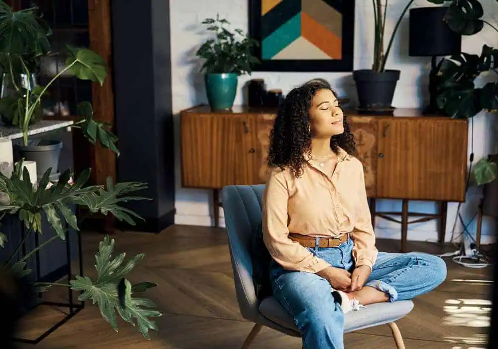 Woman sitting in a quiet, peaceful room with laminate flooring