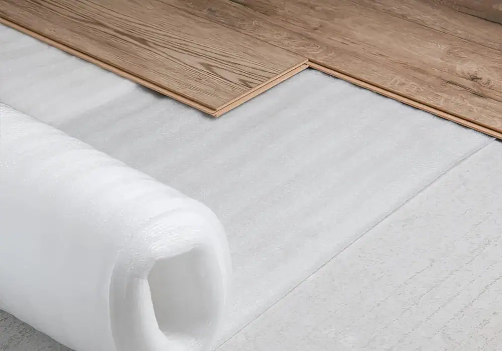 Roll of foam laminate underlay underneath wood effect planks