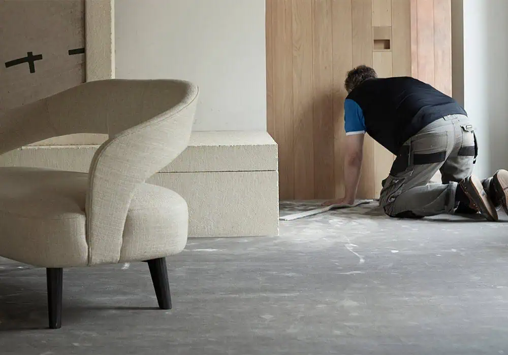 Professional carpet fitter installing a high end velvet carpet