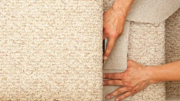 UK carpet fitter installing a stair carpet