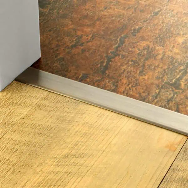 Stairrods Premier 40mm Stick Down Cover Threshold Strip in Antique Brass between two hard floors