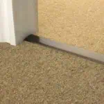 Stairrods Double Z Premier Antique Bronze Threshold Strip joining carpet to carpet in a doorway