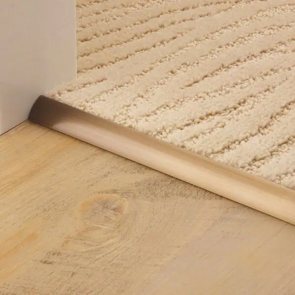 Stairrods Single 9 Premier Antique Brass Threshold Strip edging carpet to wood flooring in a doorway