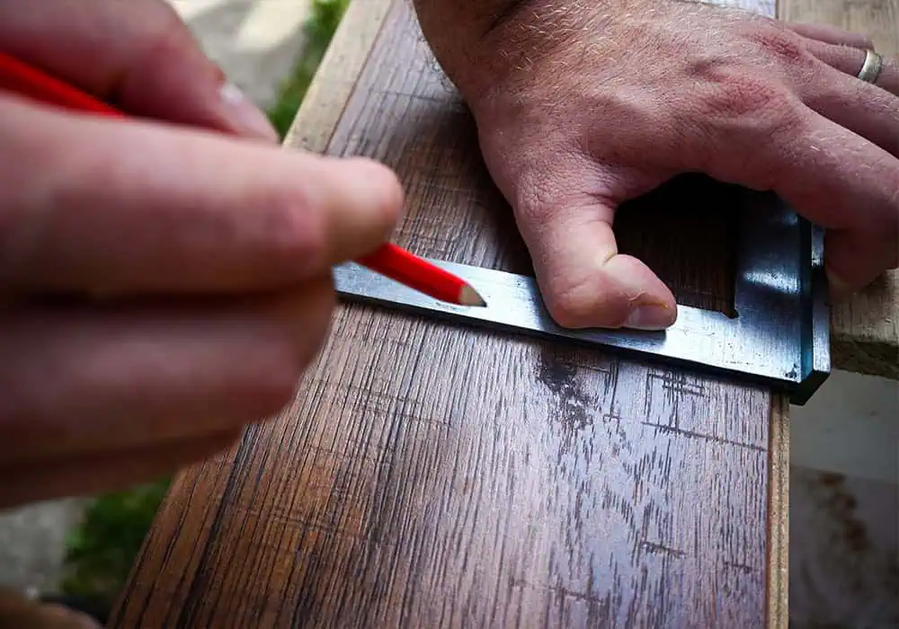 Laminate floor fitter cutting a plank ready for laying