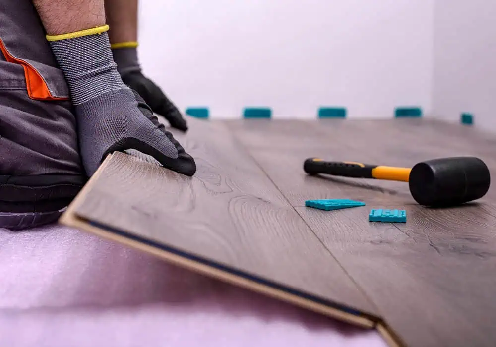 Man installing laminate flooring