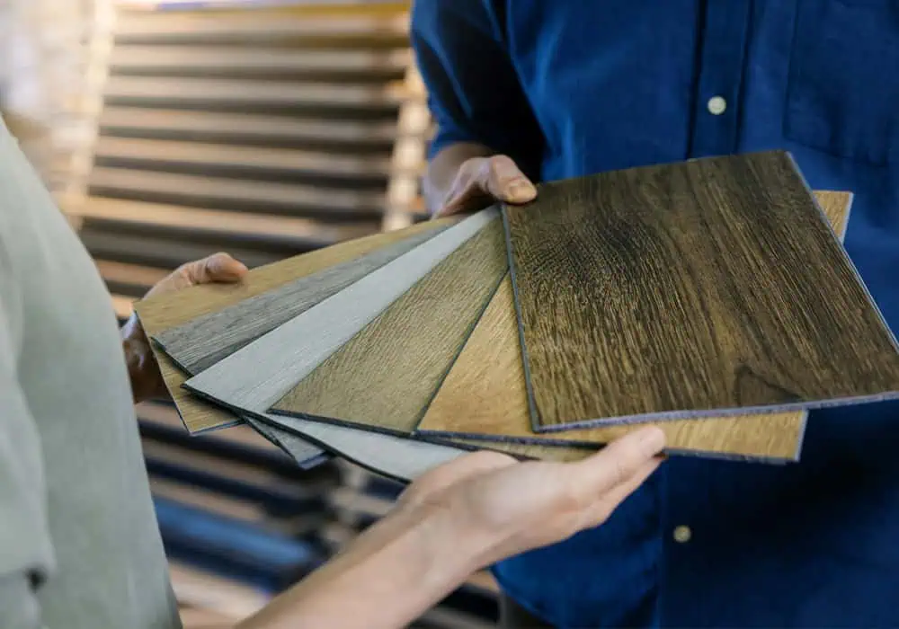 Woman choosing laminate flooring samples in a shop