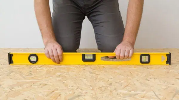 How to level a wooden subfloor using hardwood boards