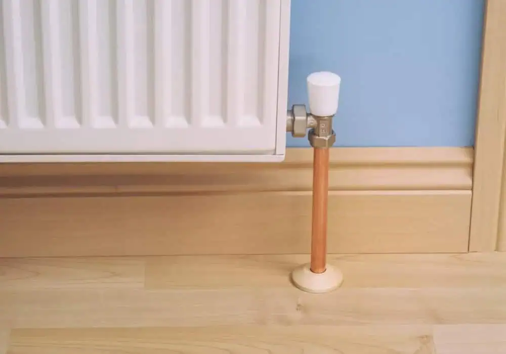 Laminate flooring with radiator pipe collar