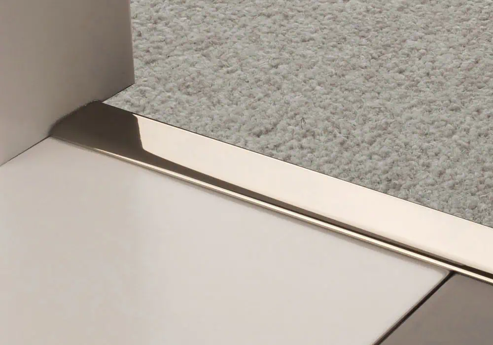 Zig Zag, Z edge door bar in polished nickel transitioning from carpet to tiles