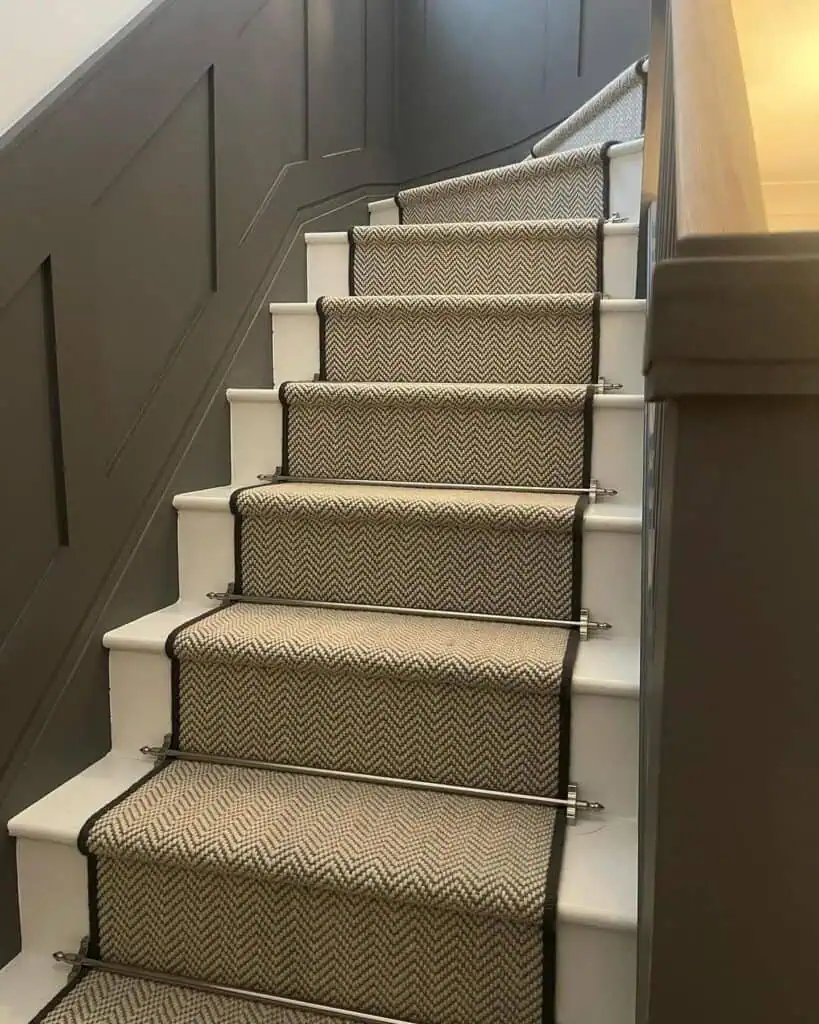 Stair case with white stairs and satin nickel stair rods