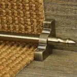 Homepride Stair Carpet Runner Rod in Antique Brass with a sisal carpet on wooden stairs