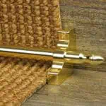 Homepride Stair Carpet Runner Rod in Shiny Brass with a sisal carpet on wooden stairs