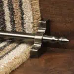 Homepride Stair Carpet Runner Rod in Pewter with a striped carpet on wooden stairs